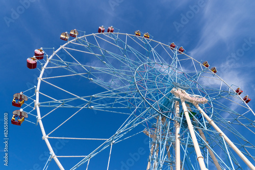 Ferris wheel against the blue sky. Modern Ferris wheel. Big, tall white Ferris wheel in front of a perfect blue sky. Happy summer vacation feelings. Sochi Ferris wheel 