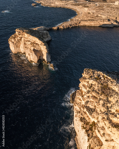 Aerial view of rugged coastline and steep cliffs overlooking Dwejra Bay, Gozo, Malta. photo