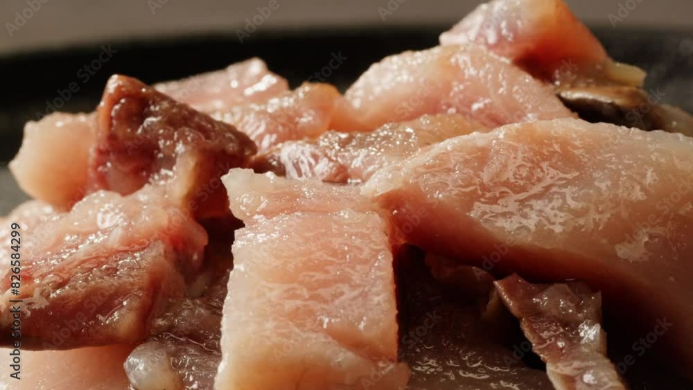 Pieces of herring fish are lying on a plate close-up macro. Herring fillet in oil and spices. Marinated cut fish for appetizer. Seafood products Pieces of herring fish are lying on a plate close-up macro. Herring fillet in oil and spices. Marinated cut fish for appetizer. Seafood products