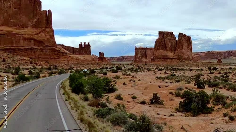 driving inside Arches National Park showing the cars on the road and the rock formations in Utah driving inside Arches National Park showing the cars on the road and the rock formations in Utah