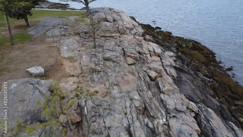Drone flying over rocky shoreline with calm sea at Davenport Park in New Rochelle, NY, USA photo
