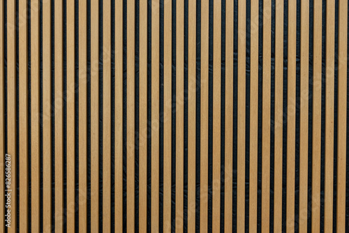 A wall of vertical wooden strips in warm colour, interior decoration background. 