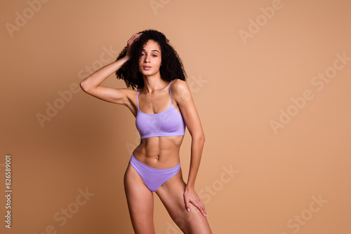 No filter photo of charming lovely athletic woman wear comfortable lingerie isolated on beige color background