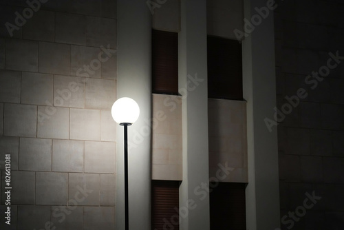 lamp at night near the wall of a house