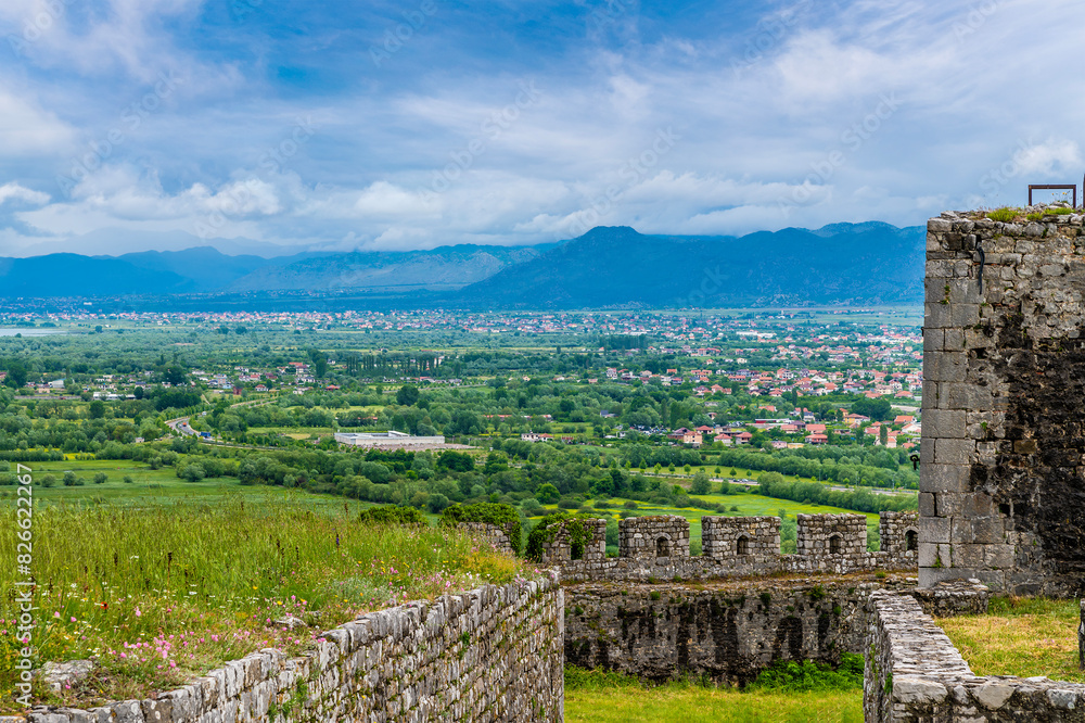A view past the ramparts of Rozafa castle towards the city of Shkoder in Albania in summertime