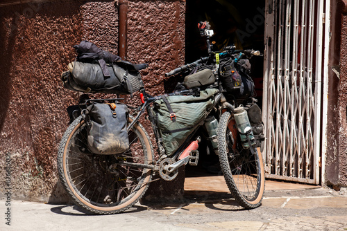 Bicycle of a traveler  next to a store in the central square of the at the heritage town of Salamina in Colombia