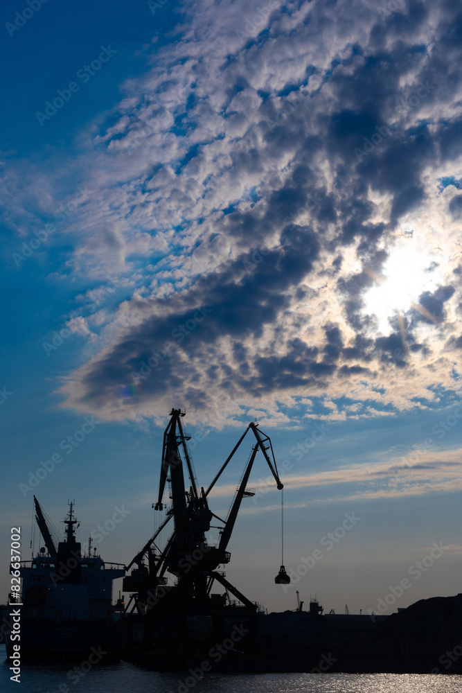 Gdynia port at sunset time,  silhouettes and sea, Poland