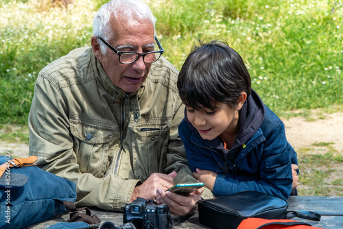 Grandfather and grandson enjoying a spring weekend outdoors photo