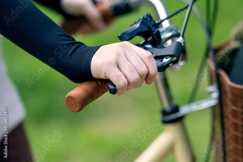 Child hand mistakenly pressing on a bicycle handbrake lever