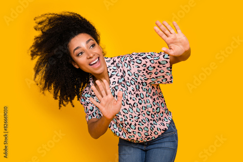 Photo portrait of lovely young lady fluttering hair wind dressed stylish leopard print garment isolated on yellow color background