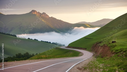 road in the green hills at foggy sunrise gil su valley in north caucasus russia photo