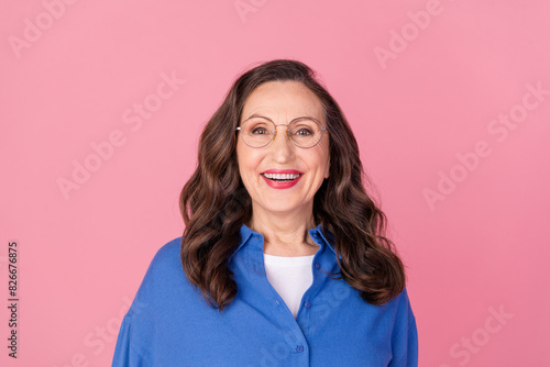 Photo portrait of attractive retired woman cheerful look camera dressed stylish blue clothes isolated on pink color background