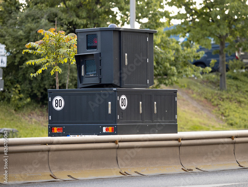 Speed camera on a trailer set up next to a big street. Technology to measure the speed of the car drivers. The black box is hidden and takes photos of fast cars. German law enforcement on the streets.