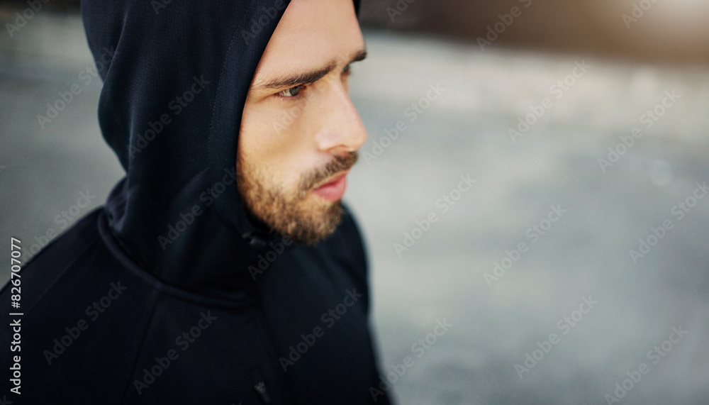 Man, thinking and hoodie in city for workout, exercise and training on sidewalk for wellness. Runner, mockup and determined in urban area for fitness, health and fatigue from physical activity Man, thinking and hoodie in city for workout, exercise and training on sidewalk for wellness. Runner, mockup and determined in urban area for fitness, health and fatigue from physical activity