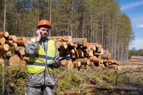 Forest engineer working in the forest with a satellite phone. Forestry engineer.