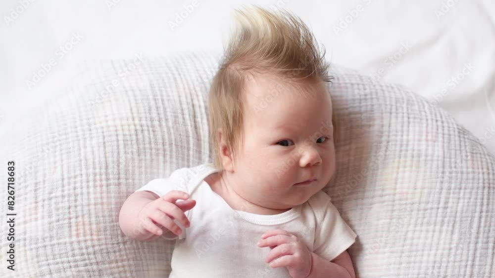 4K video of a Cute Caucasian newborn baby with hair looking around. Face expressions of the newborn baby girl 4K video of a Cute Caucasian newborn baby with hair looking around. Face expressions of the newborn baby girl