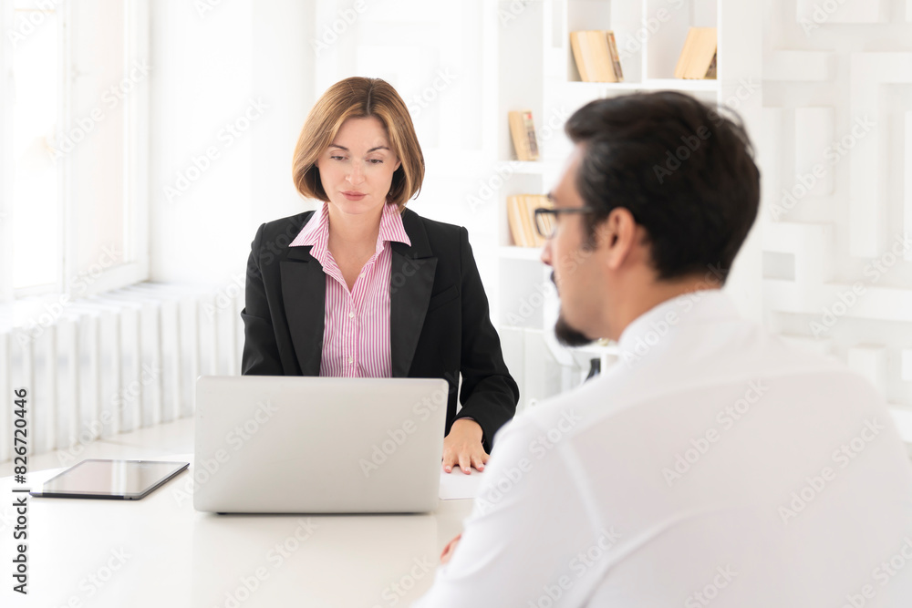 Young HR specialist conducting an interview with an ambitious candidate in the office Young HR specialist conducting an interview with an ambitious candidate in the office