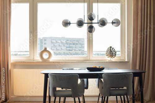 Dining room with lemons on the table, modern light fixture in modern apartment