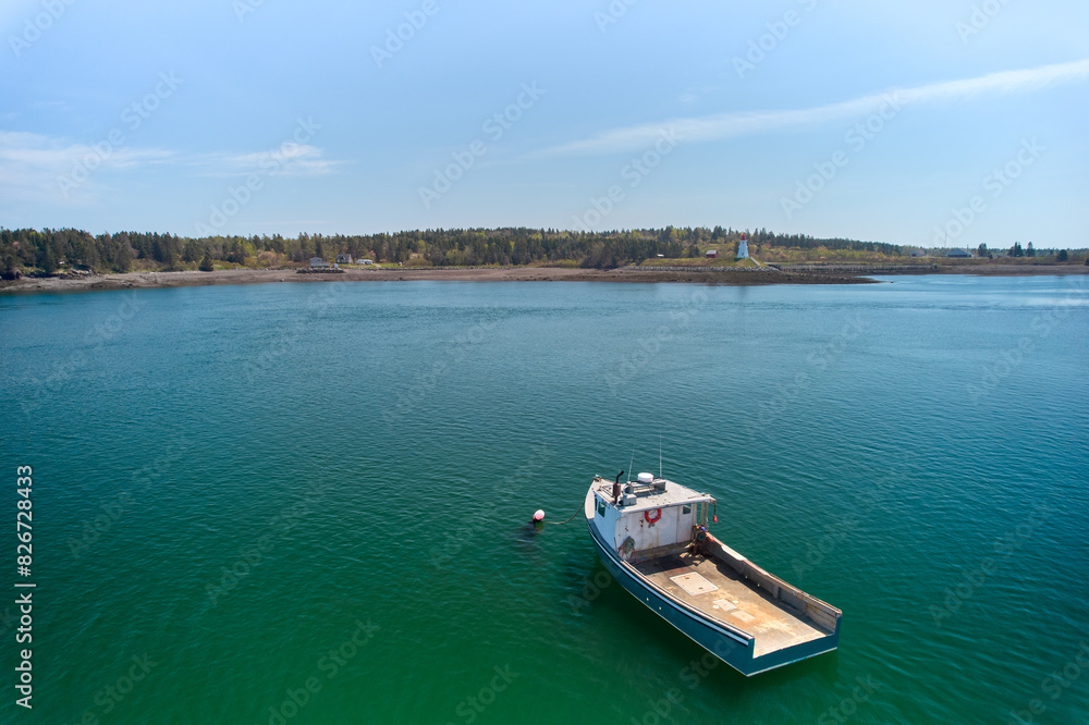 Aerial Drone images of the Lobster fishing fleet out of Lubec Maine on Johnsons Bay which is on the Canadian Border with the Mulholland Lighthouse in Canada in the background