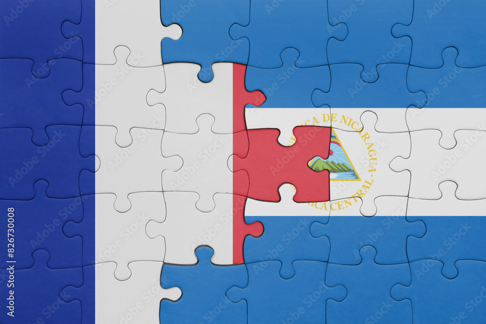 puzzle with the colourful national flag of nicaragua and flag of france.