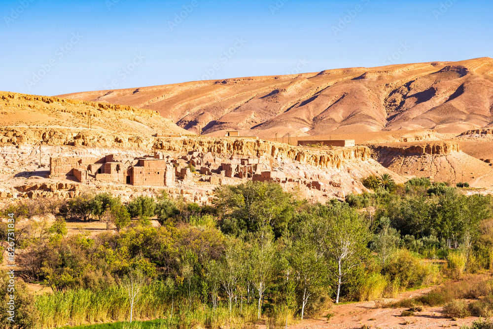 View of small village with clay and brick houses in mountain valley near Tinghir town, Morocco, North Africa