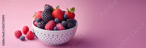 Mixed Fresh Berries in a Bowl Isolated on Gradient Background from Purple to Pink with Copy Space