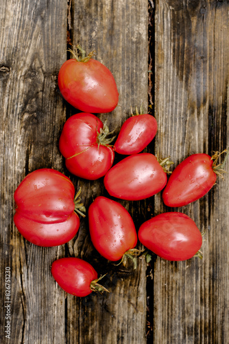 tomatoes on the rustic wooden background. red tomatoes on the open air.