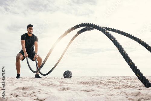 Fototapeta Naklejka Na Ścianę i Meble -  Fitness, with battle rope on beach for endurance challenge, strength or core training in outdoor. Exercise, sports and male athlete for muscle development, intense performance or full body workout