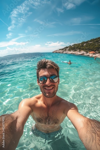 a happy man takes a selfie against the background of the ocean. Selective focus