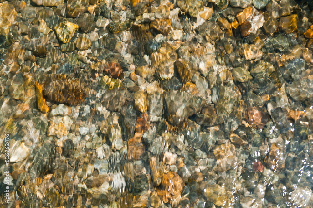 texture of peebles covered in a layer of clear flowing water texture of peebles covered in a layer of clear flowing water
