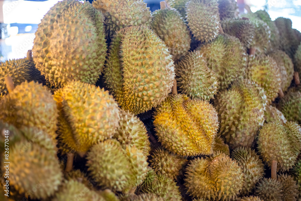 Large spiky durian fruits on a store counter in Asia. Thai fruit market Large spiky durian fruits on a store counter in Asia. Thai fruit market