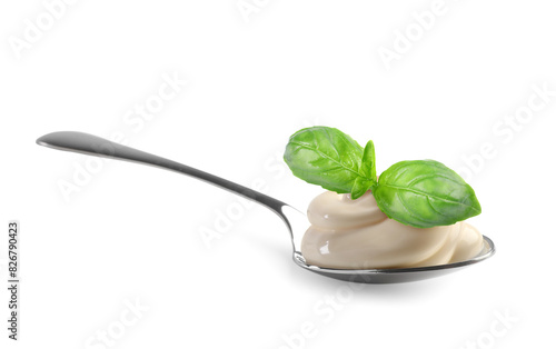 Spoon with delicious yogurt and basil isolated on white