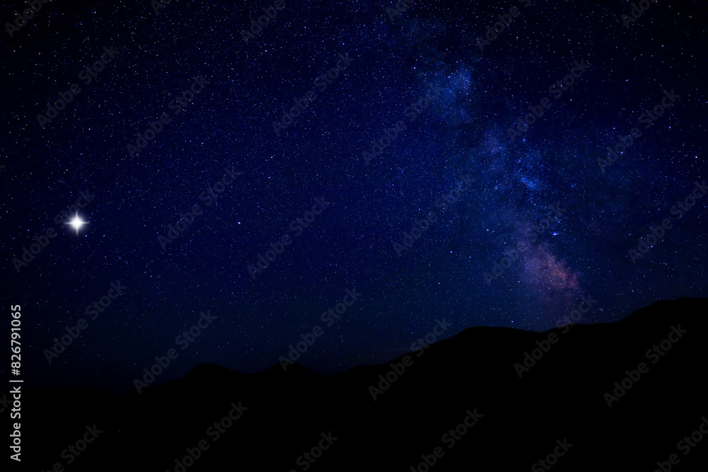 Sky with twinkling stars over mountains at night Sky with twinkling stars over mountains at night