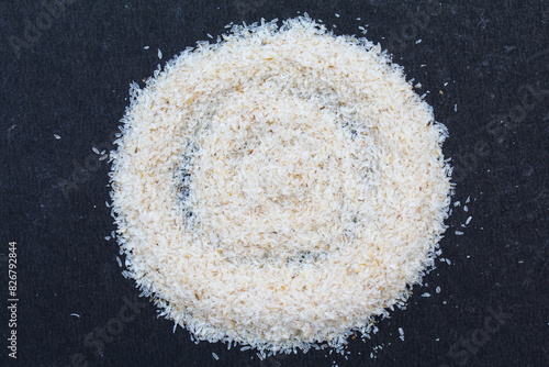 Psyllium husk or isabgol husk on black background close-up view  photo