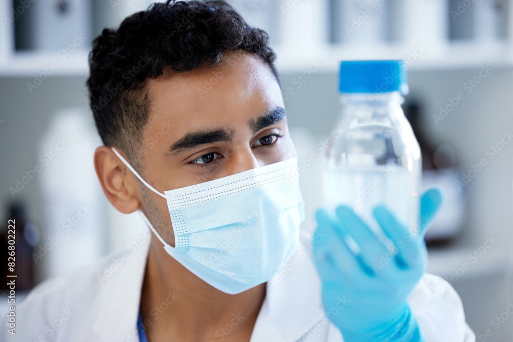 Science, bottle and man with mask, solution in container and medical research in laboratory. Vaccine innovation, scientist or lab technician with liquid, glass or pharmaceutical development with ppe Science, bottle and man with mask, solution in container and medical research in laboratory. Vaccine innovation, scientist or lab technician with liquid, glass or pharmaceutical development with ppe