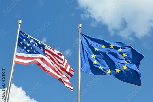 Flags of the USA and EU waving against a blue sky with clouds.