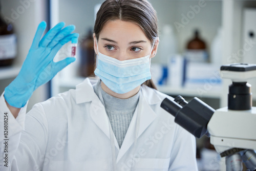 Woman  student and blood sample with scientist research and university lab with study. Medical  education and pathology with virus and chemistry project with tube and college classroom with mask