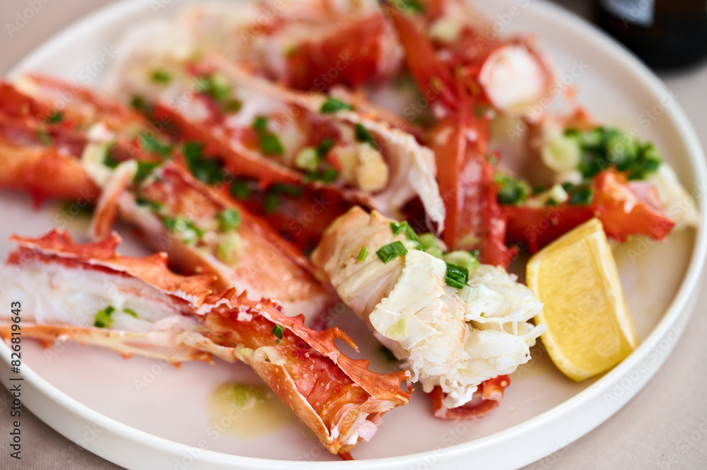 Cooked langoustine claws in a plate with lemon and spices