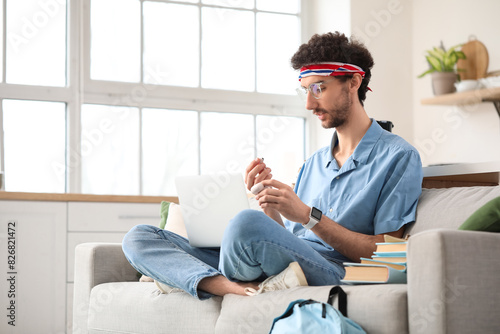 Male student studying with ...