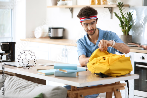 Male student studying at ta...