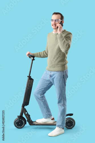 Young man with kick scooter...