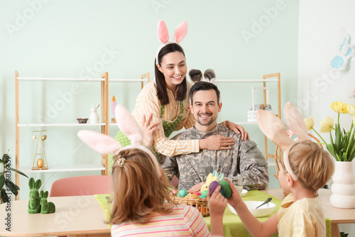 Male soldier with his famil...