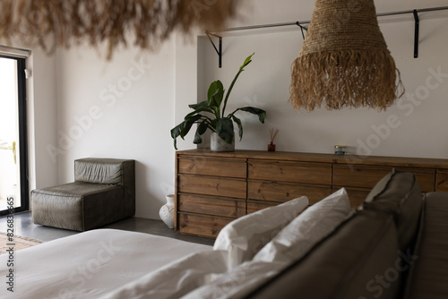 At home, rustic wooden furniture and large plant dominating a bedroom photo