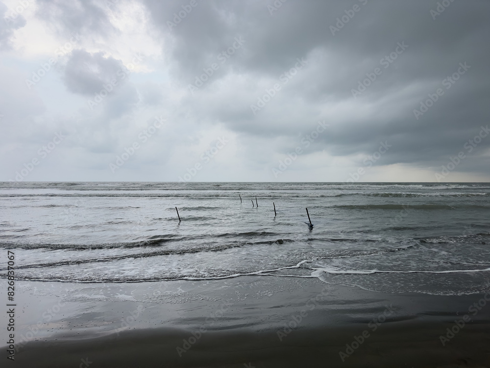 Fototapeta premium Traditional fishing nets on deserted beach with storm in background, Cox's Bazaar, Bangladesh