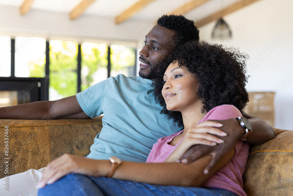 A diverse couple relaxing at home, enjoying peaceful moment A diverse couple relaxing at home, enjoying peaceful moment
