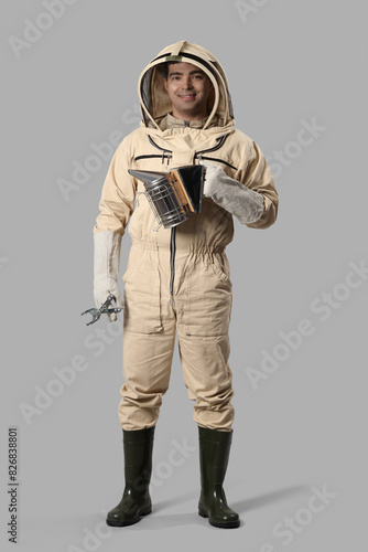 Male beekeeper with supplie...