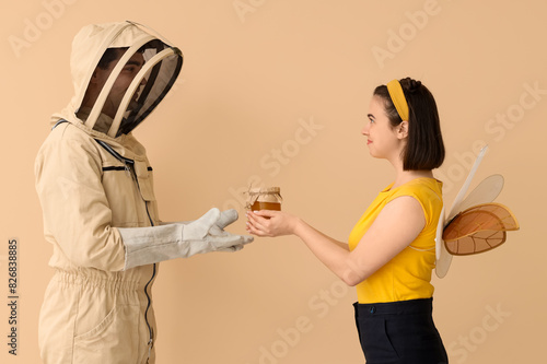 Male beekeeper with jar of ...