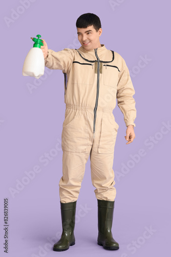 Male beekeeper with sprayer...