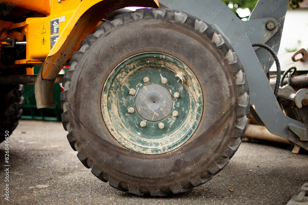 Side view of a large excavator tire. Construction site, nobody. Close up.
Side view of a large excavator tire. Construction site, nobody. Close up.