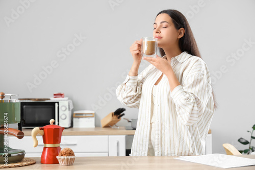 Pretty young woman with cup...
